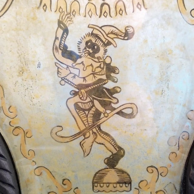 A whimsical monkey painted on a silver leaf background framed with glass and wood. Two swan arms hold candelabra light...