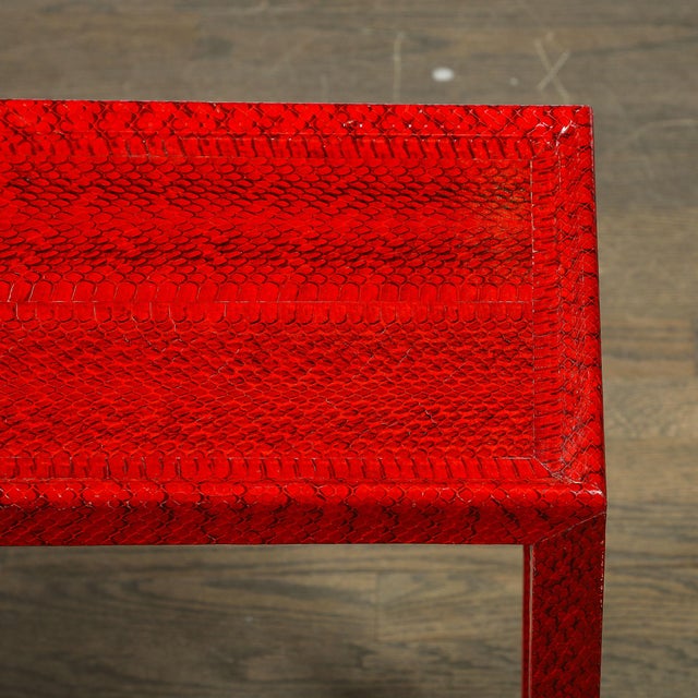 A glamorous Mid-Century Modernist side table, designed by the celebrated Karl Springer, featuring luxurious smoked ruby...