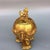 Ornate lidded gilded bronze incense burner with a matching integrated base. The domed lid is crowned with a foo lion...