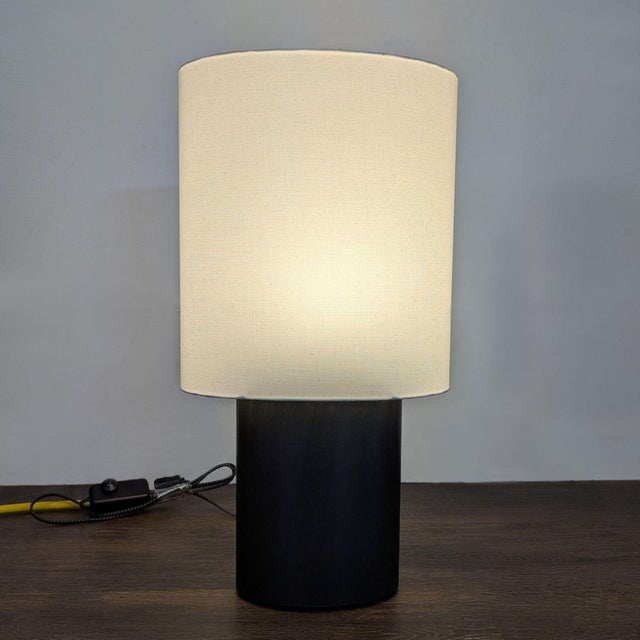 Upgrade your space with this Room & Board table lamp. It features a sturdy black oak wood base and a clean white fabric...