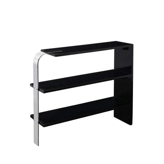 This exquisite Art Deco three-tier end table or bookcase, crafted in America circa 1935, showcases the streamlined...