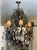 Grand Louis XV-style multi-light chandelier featuring an ornate scrolling metal frame lavishly adorned with faceted...