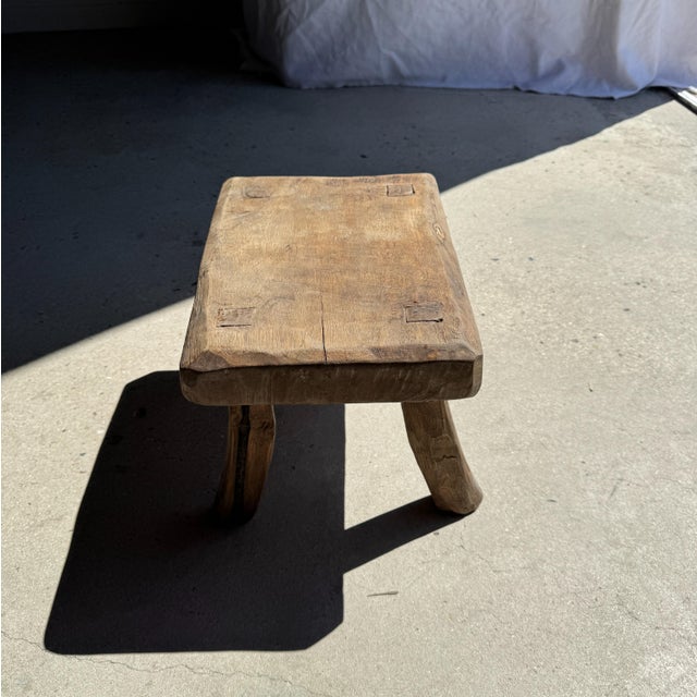 Small rectangular teak stool in wabi-sabi style. Minimalist, raw design; a beautiful, high-quality piece (thickness and...