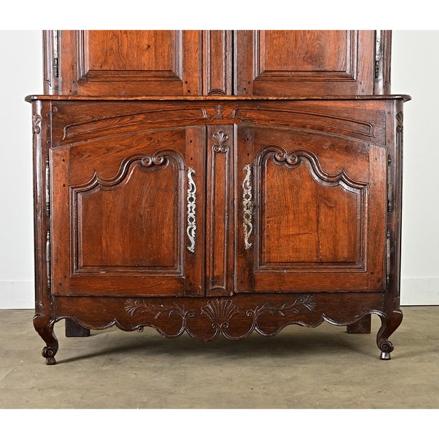 A French solid oak buffet à deux corps from the 19th century (Louis XV in style) with baroque carvings to add depth to the...