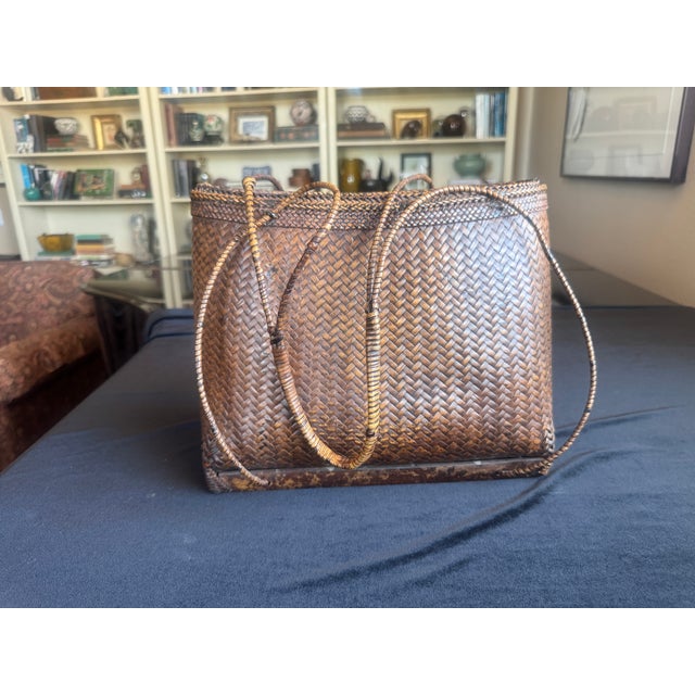 A hand-woven rattan market basket with the deep amber patina that only decades of use produce. Fine diagonal twill...
