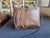 A hand-woven rattan market basket with the deep amber patina that only decades of use produce. Fine diagonal twill...