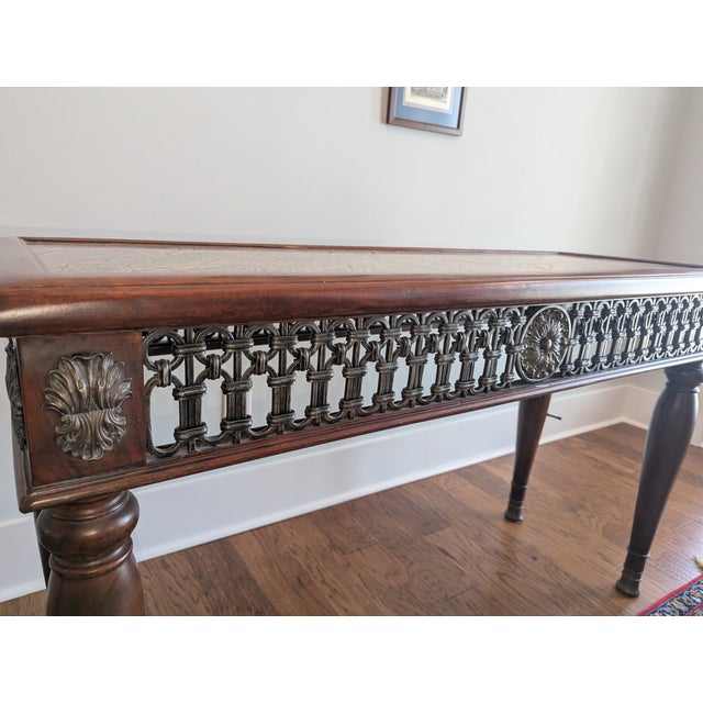 Theodore Alexander Morgan Hill Console Table. Solid mahogany featuring an inlaid marble top and (bronze and/or brass)...