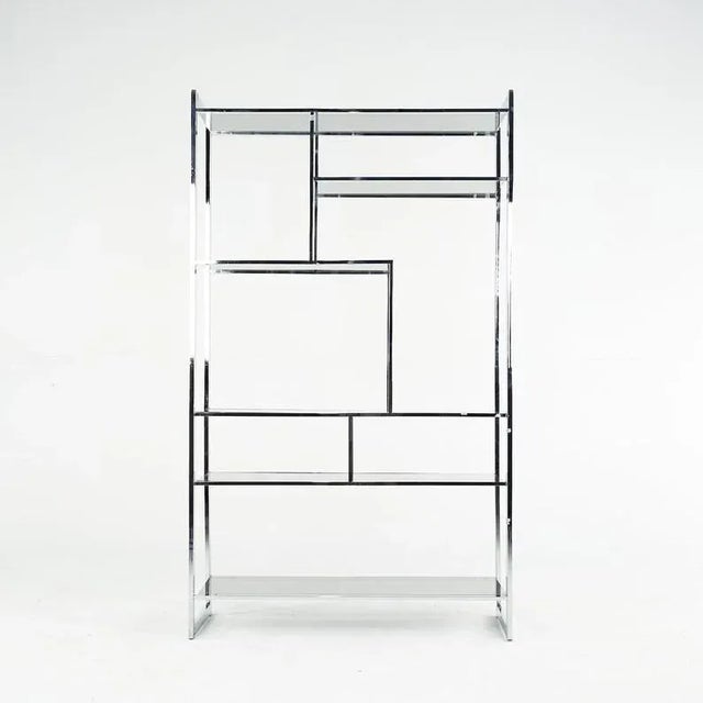Circa 1975. Features smoked glass shelves in two sizes. It has polished chrome exterior frame which has been recently...