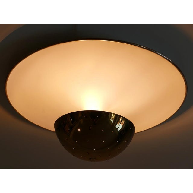 Extremely rare, large and elegant mid-century modern flush mount or sconce. With perforated brass diffusor. This is a very...