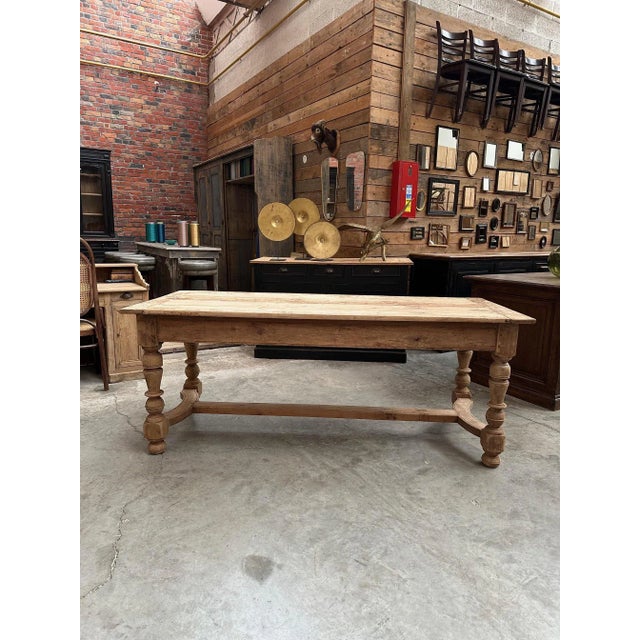 This old farm table in cherry wood has been fully restored. It features a retractable shelf at one end and a functional...