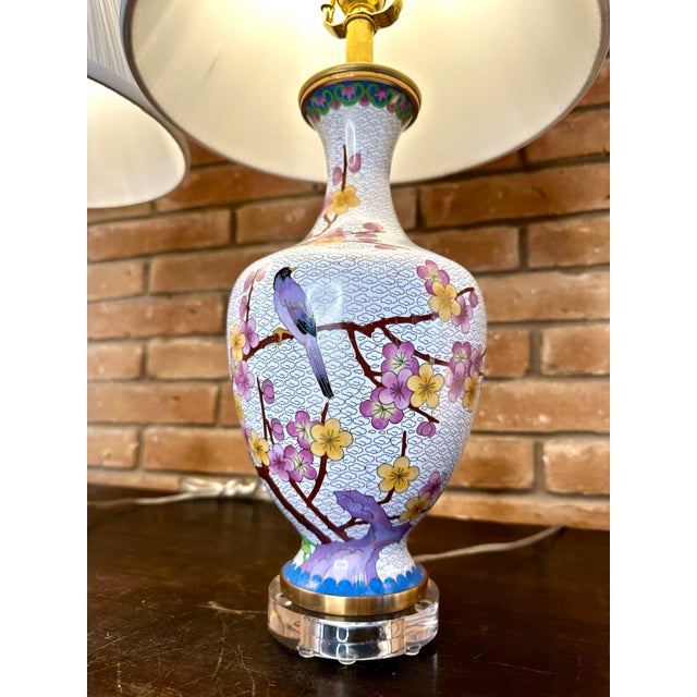 Classic Cloisonné vases converted in to lamps on Lucite bases. The pattern features a "birds and blossoms" theme in mirror...