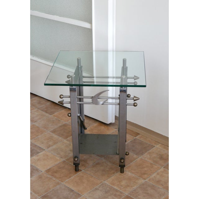 Postmodern side table made of steel and tempered glass! The table is a real statement piece and is in a great condition.