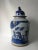 This blue and white porcelain jar is adorned with hand painted children happily playing outside on one side and simple...