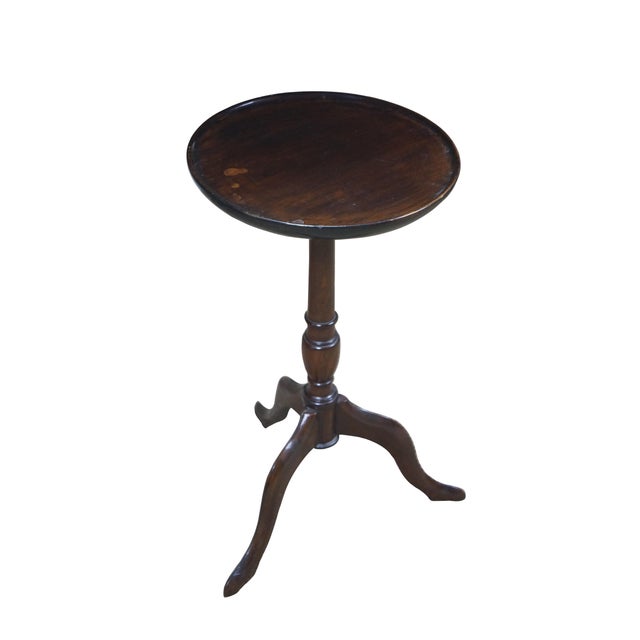 Circa mid 20th century mahogany candle / plant stand with round top, turned pedestal base and tripod feet. Top screws onto...