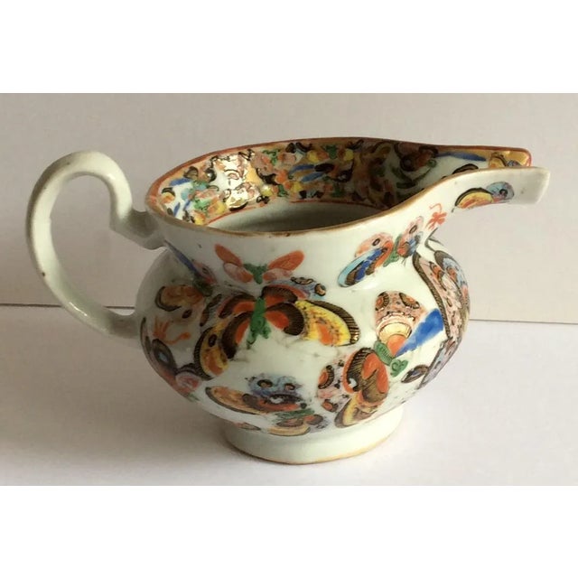 Great looking fine rare butterfly pattern gravy or creamer.