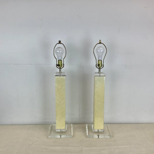 This impressive pair of tall vintage modern table lamps features a mixed material construction using clear lucite and...