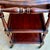 Elegant Spanish wooden bar cart featuring a beautifully shaped drop-leaf top, turned wooden legs and three spacious tiers....
