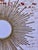Large, Stunning iconic Mid-Century Sunburst Mirror with bursts of elongating rays surrounding a round convex mirror. The...