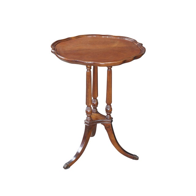 Mid Century Mersman matchbook mahogany pie crust pedestal table featuring a serpentine gallery top supported by fluted...