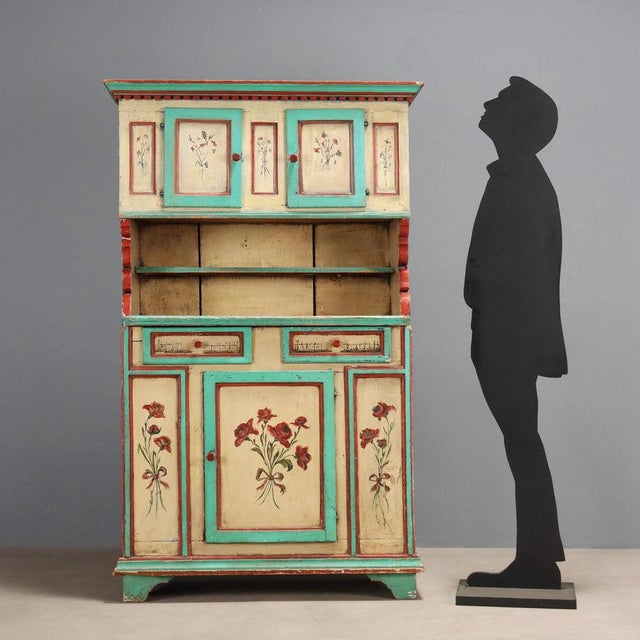 Lacquered fir sideboard painted with floral motifs, fruit, and a peacock on the top. The upper part features a pair of...