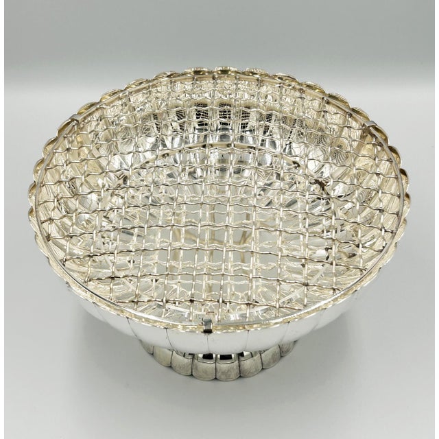 A striking vintage Japanese Pure Silver ikebana vessel, beautifully crafted in an ornate sculptural floral form. The...