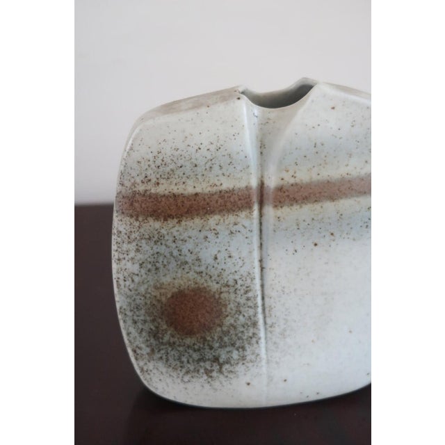 A pebble-form vase in porcelain by virebent, made in france in the 1970s. The body is squared off and split at the top...