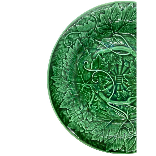 Wedgwood Majolica green glazed plate, with relief-molded grape leaves and vines, raised on a basketweave ground, the...