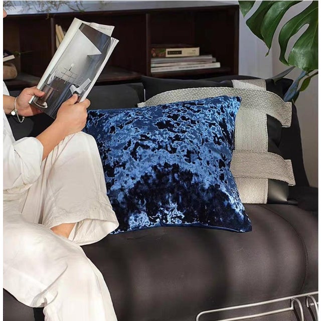 With its minimalist silhouette and sophisticated texture, this deep blue velvet piece serves as a visual focal point in a...