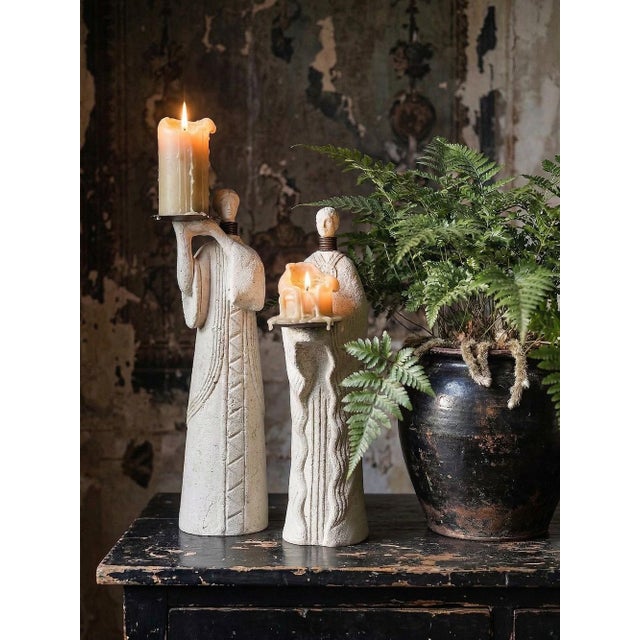 A beautiful pair of sculptural candlesticks depicting two African-style priestesses, crafted from reconstituted lava stone...