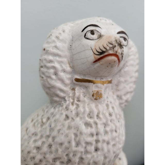 A fine, authentic pair of antique Victorian Staffordshire pottery poodle groups, hand-crafted in England circa 1870. This...