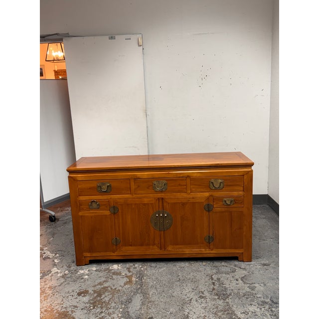 Design Plus Gallery presents a Vintage Asian Wood Sideboard . Crafted from soldi woods with natural grain and tonal...