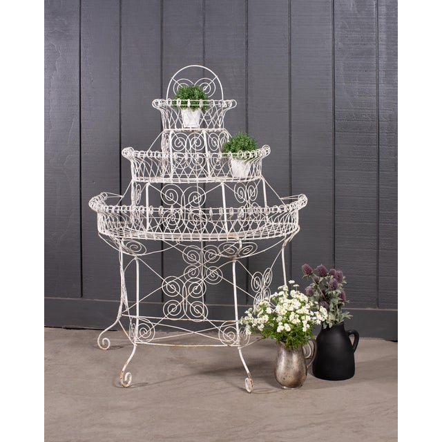 A charming English late Victorian era three-tier garden plant stand etagere or jardinière. The stand is constructed in a...