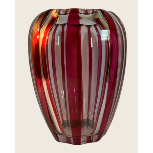 6.5” high, cranberry stripes all around in a molded Art Deco design, the model line of this vase is called Jemeppe which...