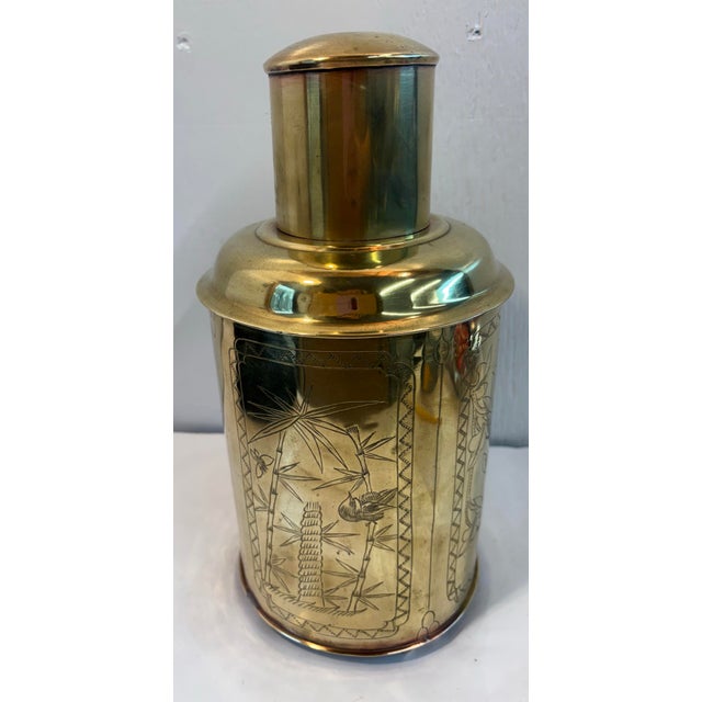 Lovely brass tea caddy featuring detailed, hand-engraved floral and bird designs.
