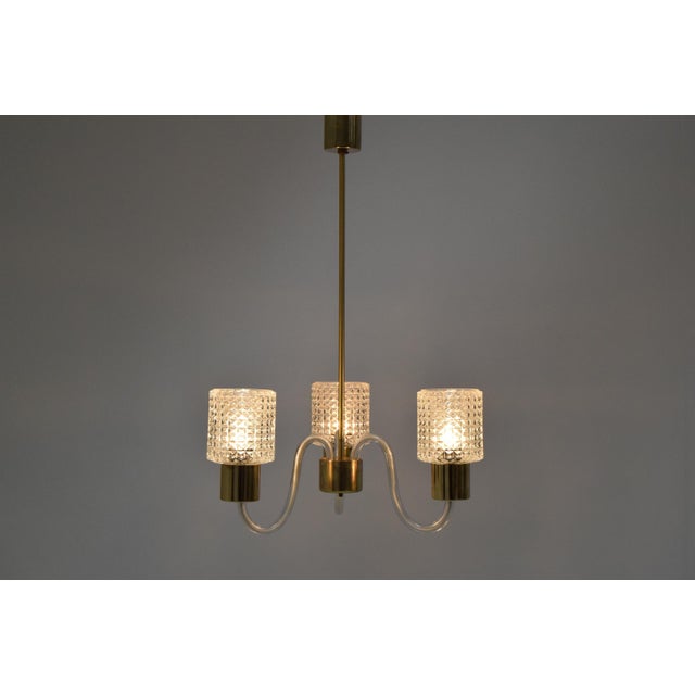 Made in czechoslovakia. Made of glass and brass. Re-polished with aged patina. 3x40w, e27 or e26 bulb. Good original...