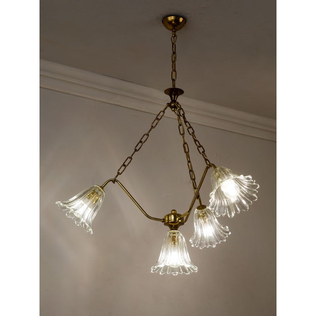 Vintage Italian chandelier from the 1950s, made of brass and Murano glass. The brass structure is composed of three arms...