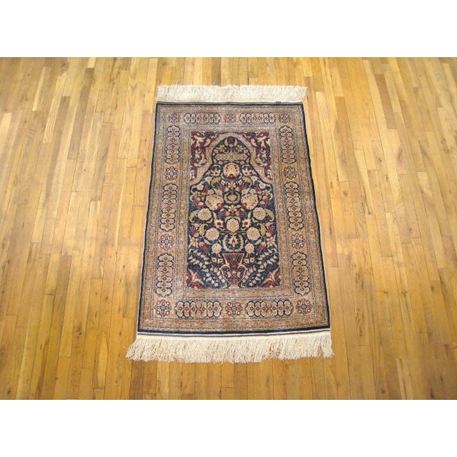 An antique Turkish silk Hereke oriental rug, size 4'6" x 3'0", circa 1920. This fine hand-knotted carpet features a...
