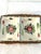 Lovely pair of mid-century porcelain bowls hand-painted in a colorful floral design with accompanying wicker basket....