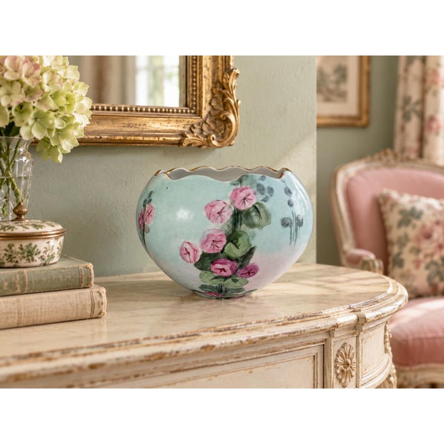 A charming early 20th-century porcelain rose bowl featuring a softly rounded, bulbous form and a deeply scalloped opening...
