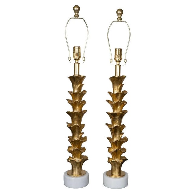 Pair of organic form composition table lamps on stone bases with golden gilt-like finish.