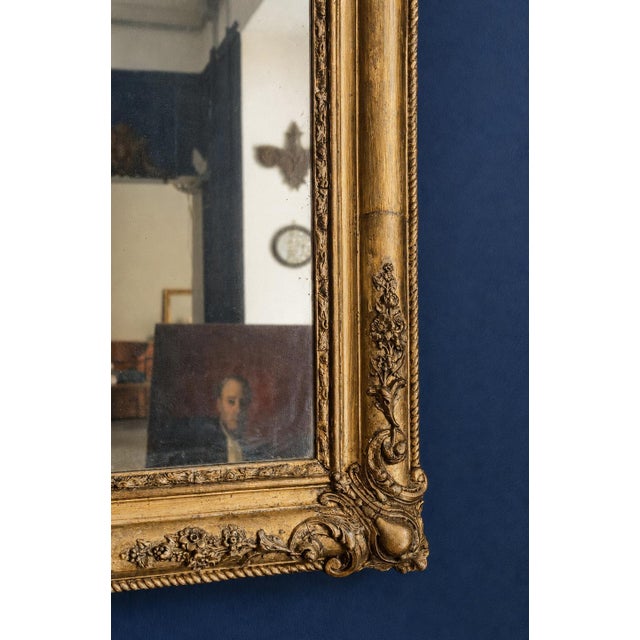 An elegant French wall mirror, likely dating to the second half of the 19th century, dating to the Napoleon III period and...
