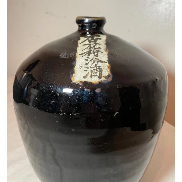Discover a piece of history with this rare antique Chinese black drip glaze pottery wine jug made in the first quarter of...