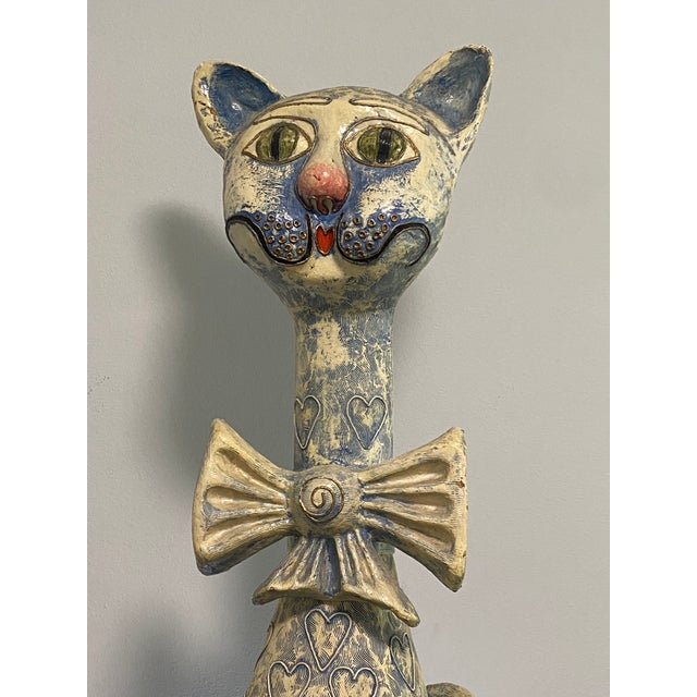 Whimsical oversized seated cat sculpture by Jeanne Valentine, handmade in Mexico from papier-mâché. The sculpture features...