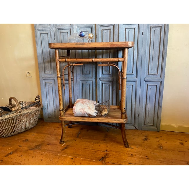 A tea trolley, also known as a table à tisane, from the aesthetic movement of late 19th-century France, also called the...