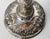 This silverplated candlestick is believed to be created by an enslaved highly skilled artisan. It features repousse...