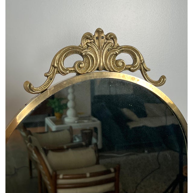 This beautiful neoclassical-style psyche mirror with pendulum is made of brass. It is a French work in the style of Maison...