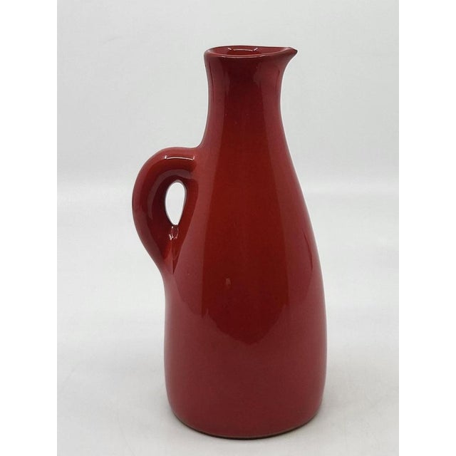 This pitcher boasts a magnificent, intense, and vibrant red, a particularly rare and sought-after color in the work of...