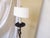 This vintage iron floor lamp has a clip on oval 9"Wide paper shade and uses an Edison base bulb up to 100 Watts.