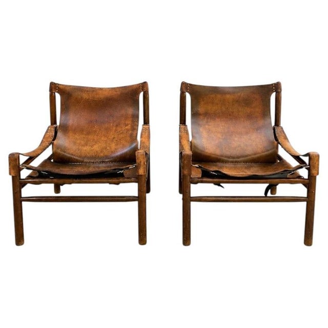Safari chairs from the 1970s. The soul of the chairs lies in the beautiful patina of the thick leather, which has been...