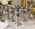 A handsome set of six vintage American cast-metal water goblets featuring bold dimensional sunburst medallions. Each...